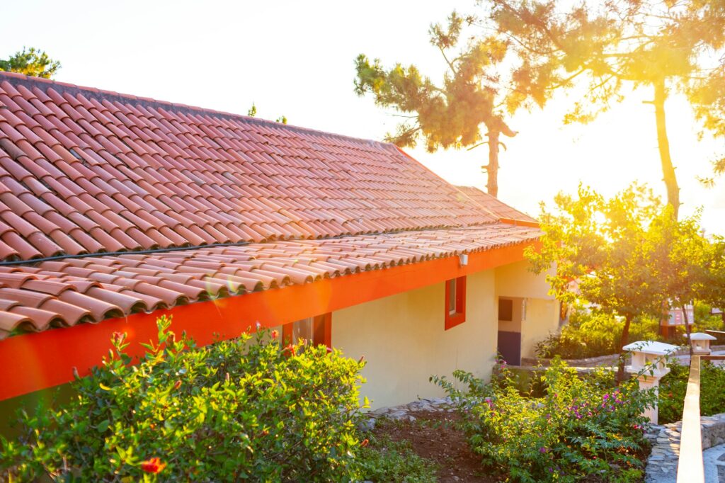 RM Roofing | little house with red terracotta roof tiles e1726486171432