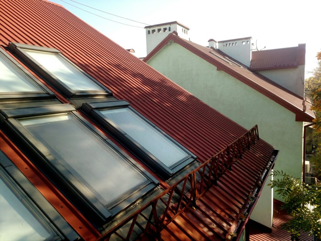 RM Roofing | red tiled house roof with attic windows roofing construction window installation