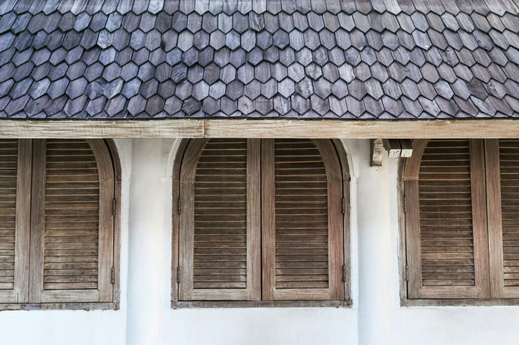 RM Roofing | wall in cafe with wooden shutters windows under tile roof