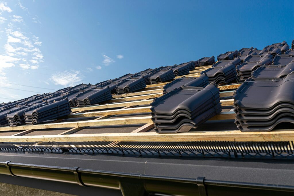 Roof ceramic tiles on battens ready for installation by Wokingham roofing specialists, roof repair, and roof replacement.Roofing Guide